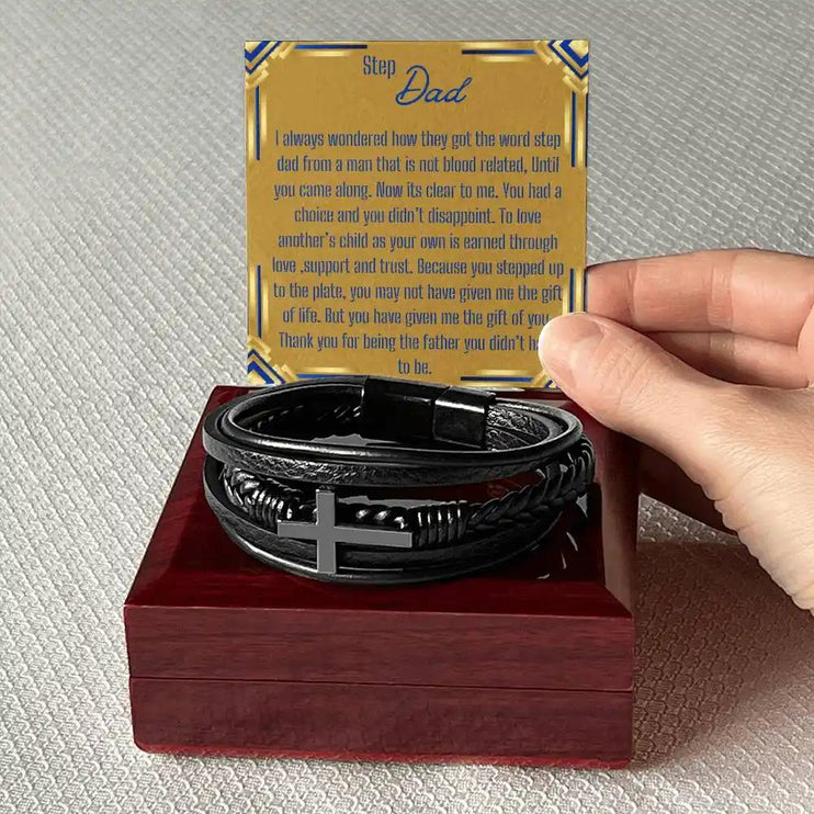 a men's cross leather bracelet in a mahogany box with a model holding the greeting card above