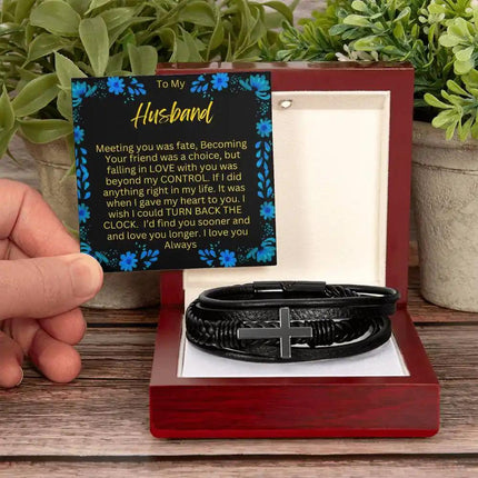 a Men's Cross Bracelet in a mahogany box  on a table