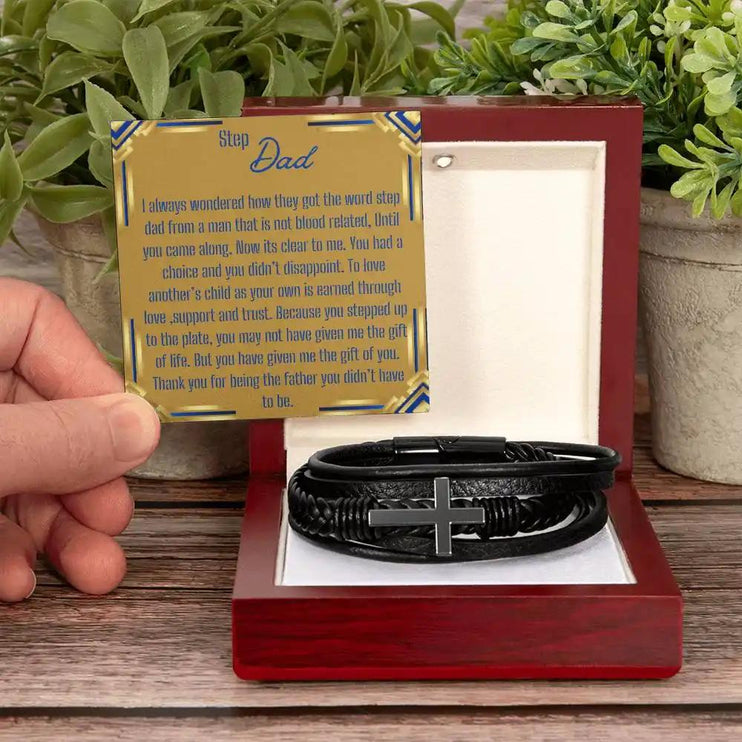 a men's cross leather bracelet in a mahogany box with a model holding the greeting card 