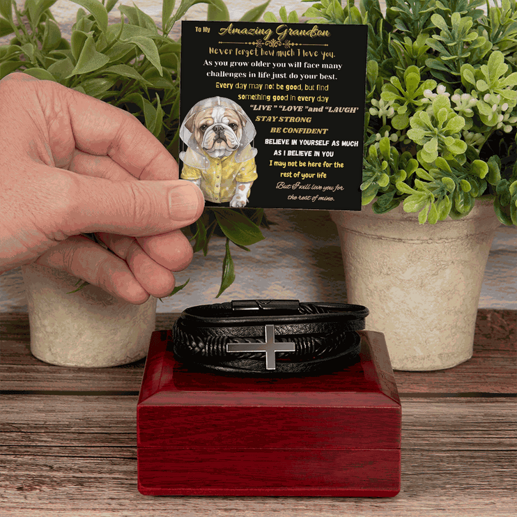 cross bracelet on top of a closed mahogany box with model holding card