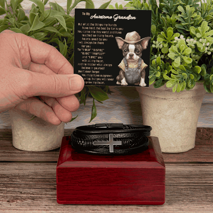 cross bracelet on top of a mahogany box with greeting card