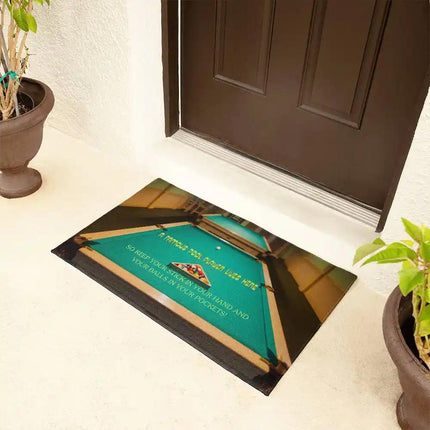a welcome mat by a brown front door with a side angle