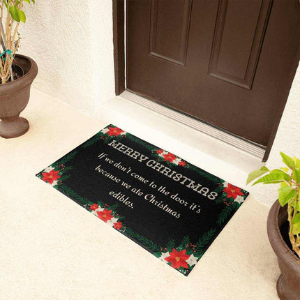welcome mat by brown door with plants