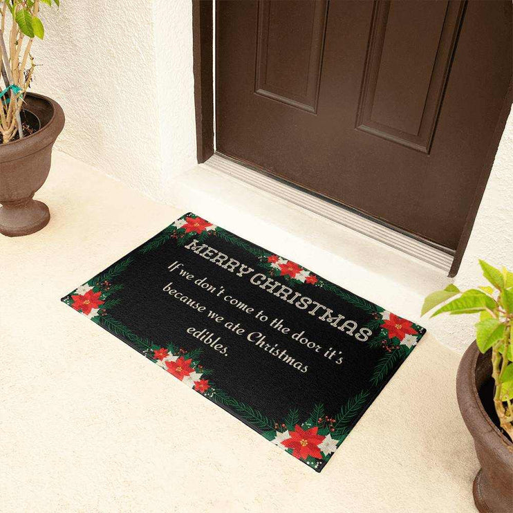 welcome mat by brown door with plants