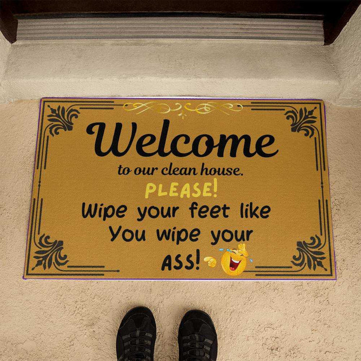 welcome mat by brown front door 