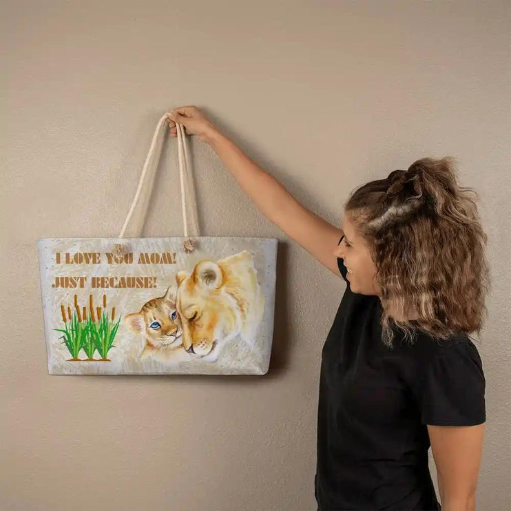 a weekend tote bag held against a wall by a model