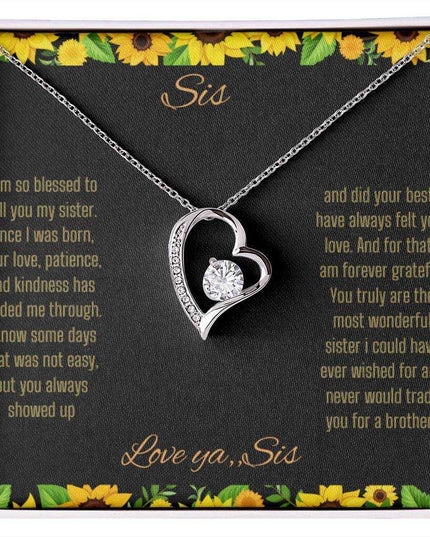 Forever Love Necklace with a white gold charm on a To Sis from Sis greeting card up close
