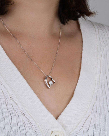 white gold forever love necklace on a model's neck