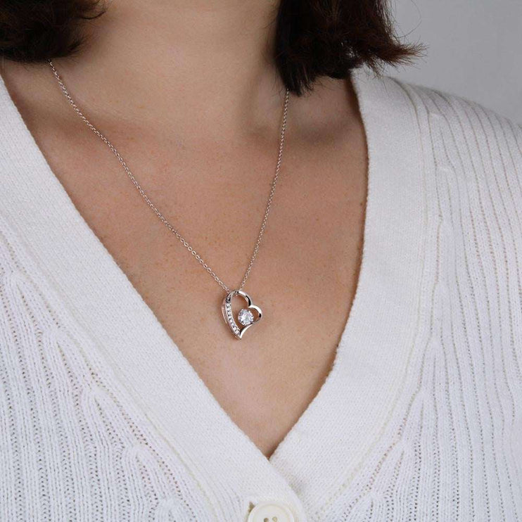 white gold forever love necklace on a model's neck