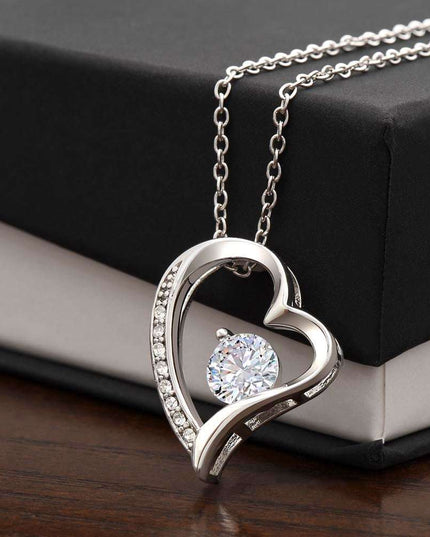 white gold forever love necklace on top of soft box