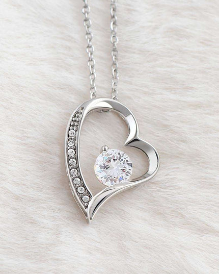 white gold forever love necklace on a white plush cloth