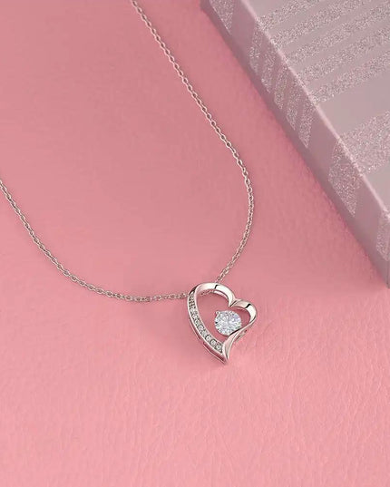 white gold forever love necklace on pink table