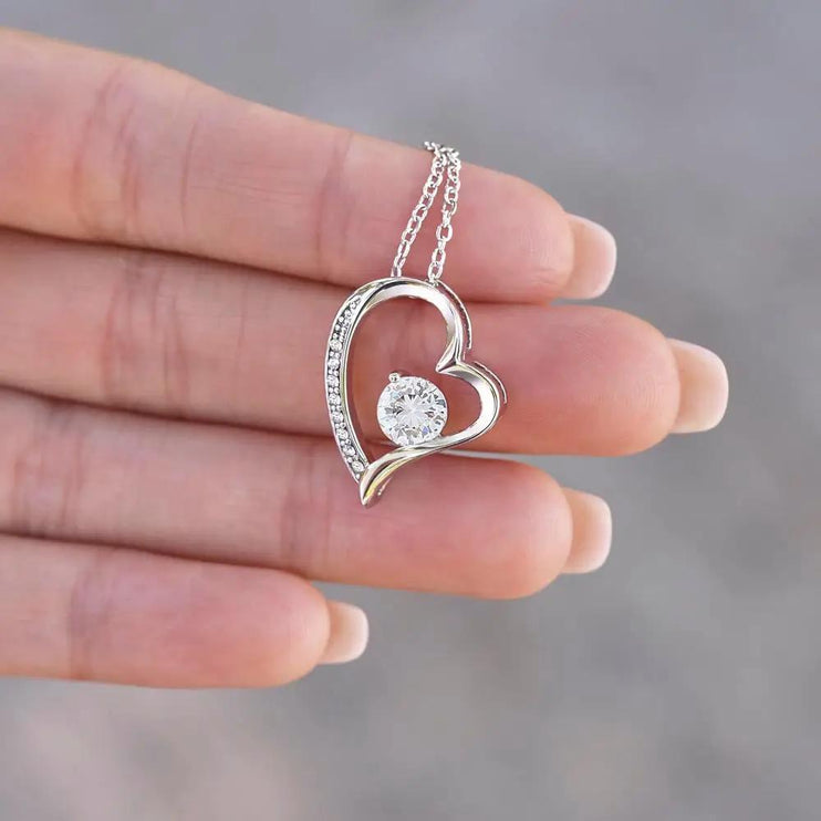 white gold forever love necklace in model's hand