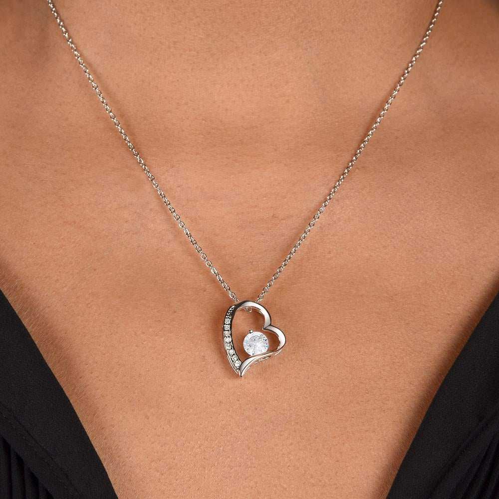 white gold forever love necklace on a model's neck