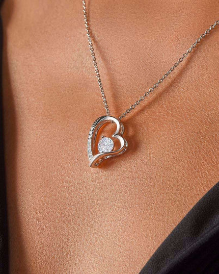 white gold forever love necklace on a model's neck