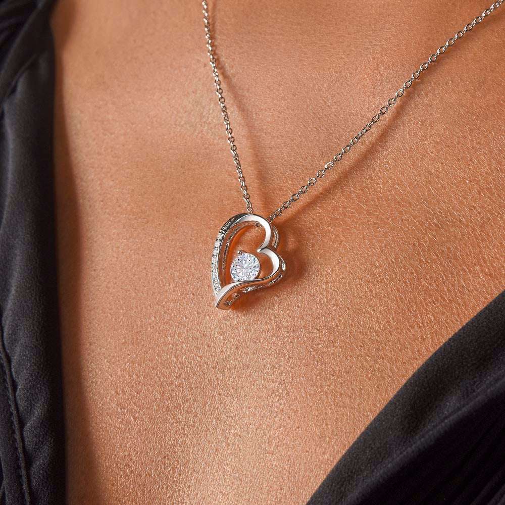 white gold forever love necklace on a model's neck