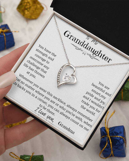 a white gold forever love necklace up close in a models hand angled to left.