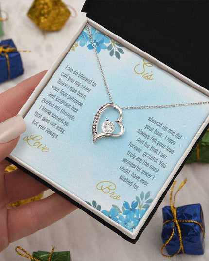 Forever Love Necklace with a white gold variant on a to sis from bro greeting card close up view in a two-tone box.