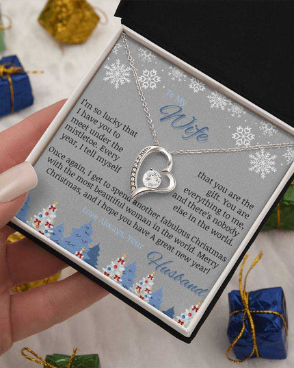 white gold forever love necklace in soft box in a model's hand