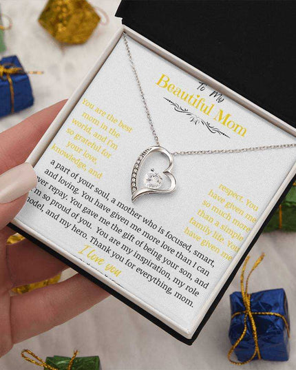 A white gold forever love necklace up close in a two-tone box in a hand