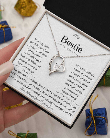 a white gold forever love necklace up close angled right in a hand