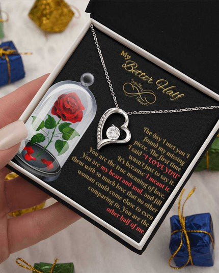 white gold forever love necklace in a soft box in model's hand
