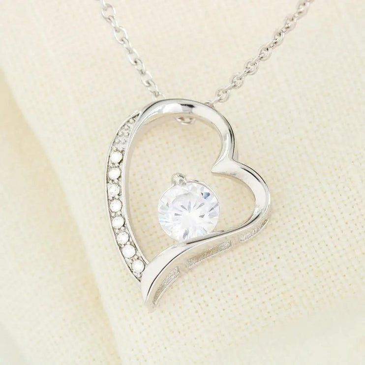 white gold forever love necklace on a white cloth