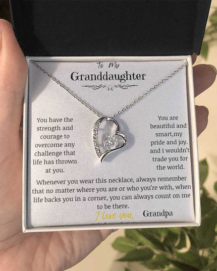 a white gold forever love necklace up close in a models hand