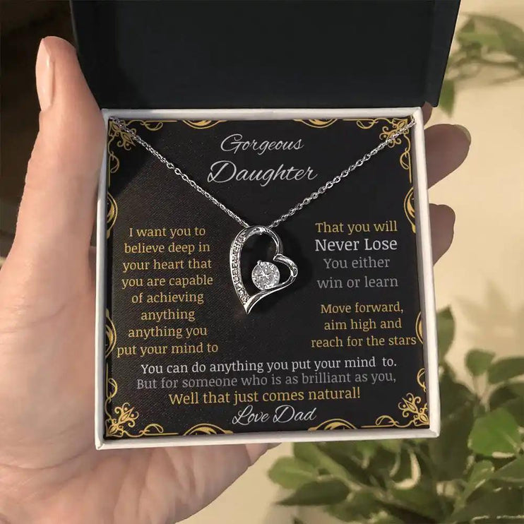 Forever Love Necklace with a white gold pendant in a two-tone box with a to daughter from dad greeting card further away in a hand