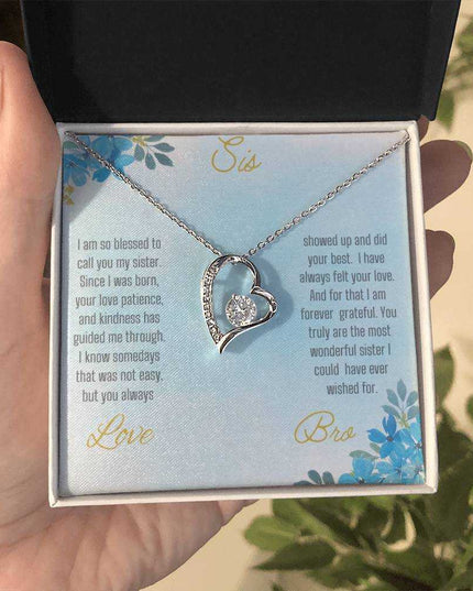 Forever Love Necklace with a white gold variant on a to sis from bro greeting card close up view in a two-tone box.