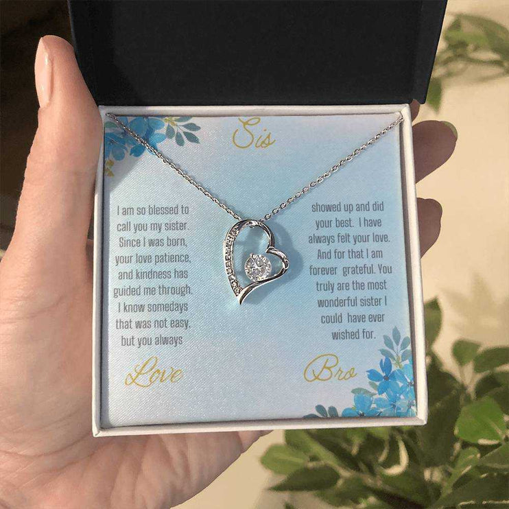 Forever Love Necklace with a white gold variant on a to sis from bro greeting card close up view in a two-tone box.