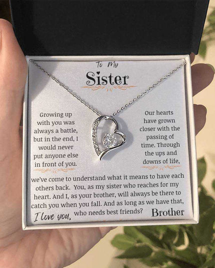 a forever love necklace up close in a models hand.