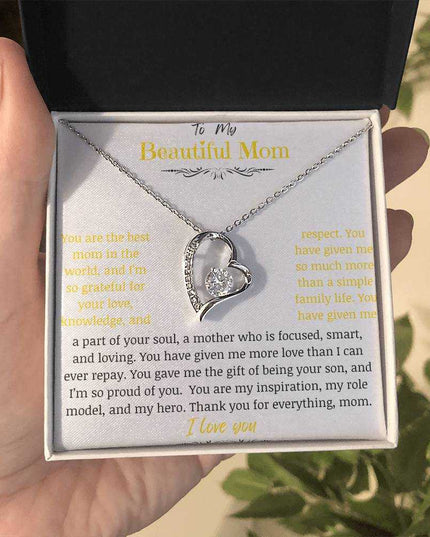 A white gold forever love necklace up close in a two-tone box