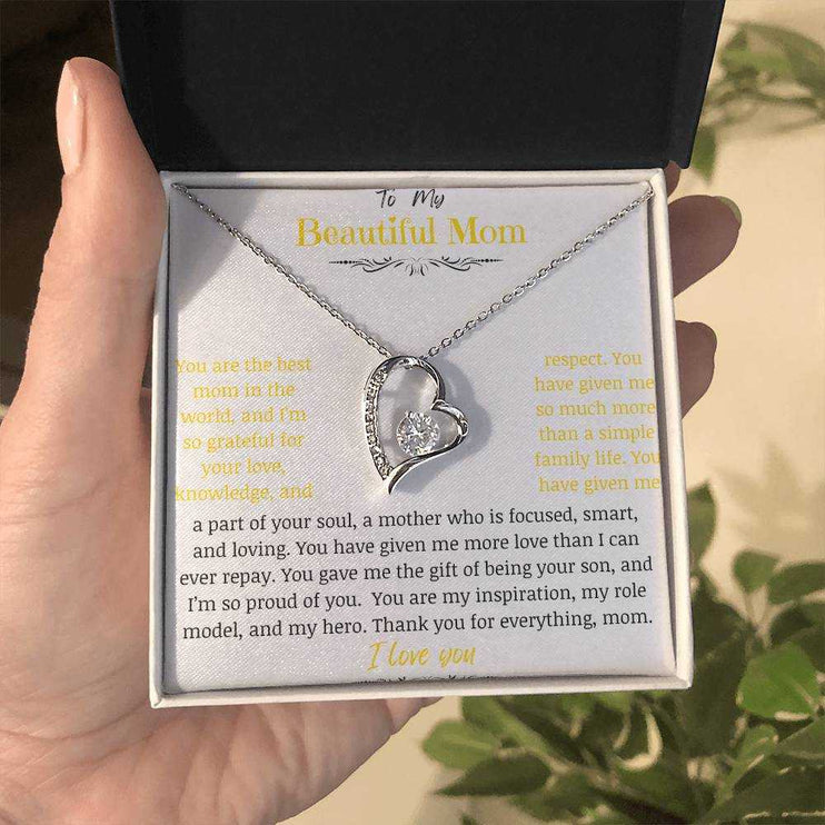 A white gold forever love necklace up close in a two-tone box