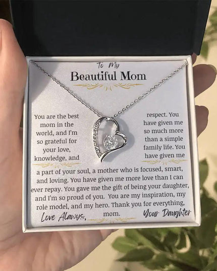 a white gold forever love necklace in models hand