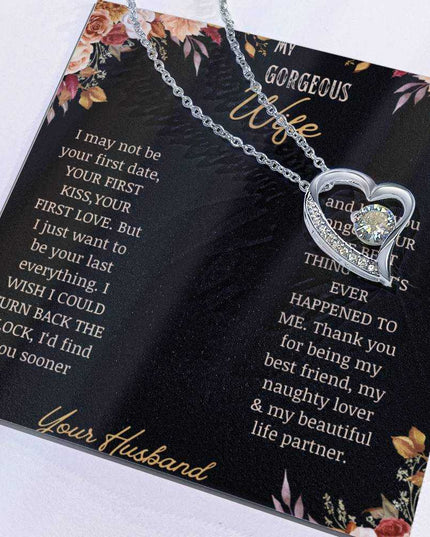 A white gold Forever Love Necklace on a to wife greeting card with the charm slid to the side.