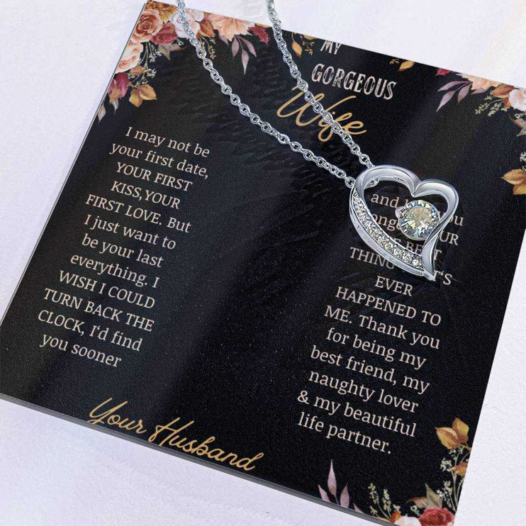 A white gold Forever Love Necklace on a to wife greeting card with the charm slid to the side.