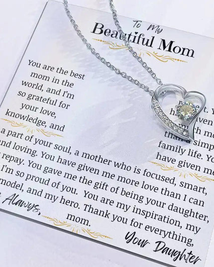 a white gold forever love necklace up close with charm slid to right