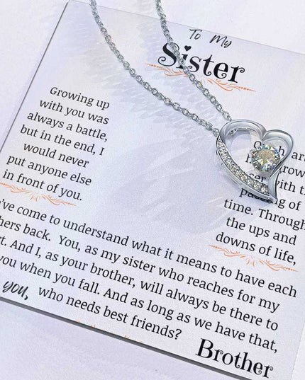 a forever love necklace up close with charm slid to the side.