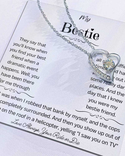 a white gold forever love necklace with charm slid to side