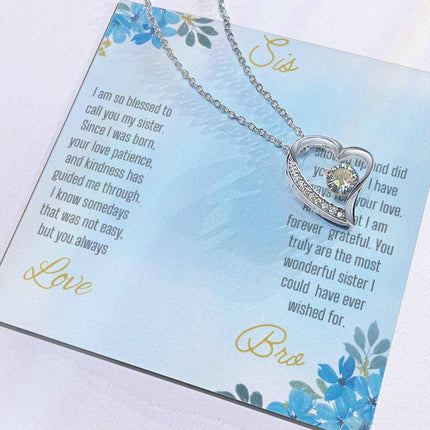 Forever Love Necklace with a white gold variant on a to sis from bro greeting card close up view in a two-tone box.