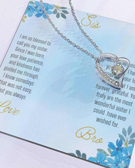 Forever Love Necklace with a white gold variant on a to sis from bro greeting card close up view in a two-tone box.