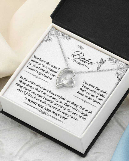 white gold forever love necklace in a soft box angled to the right