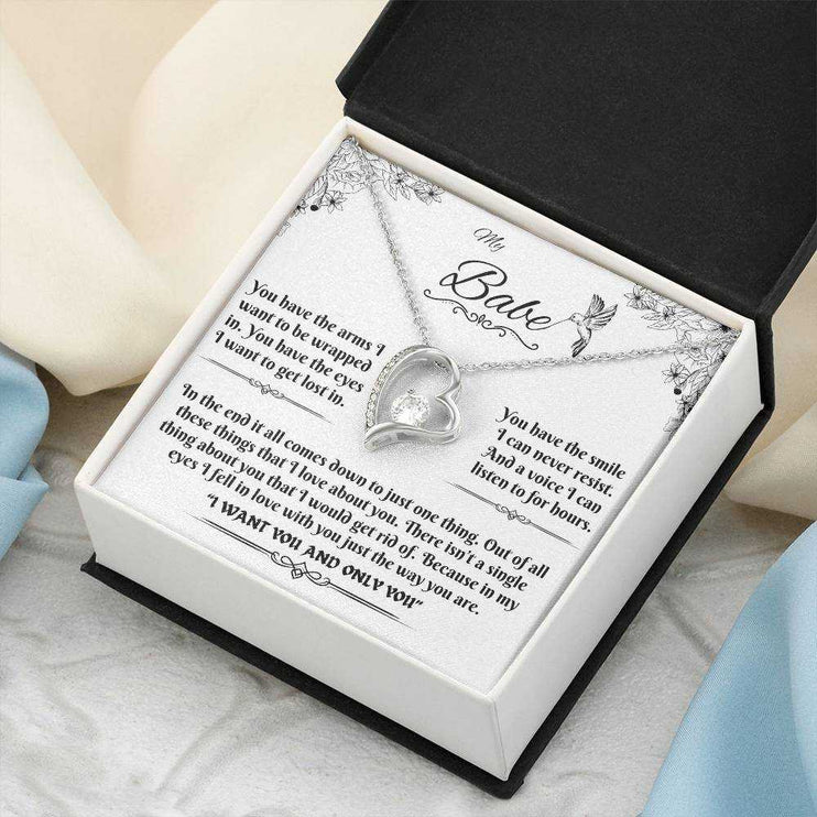 white gold forever love necklace in a soft box angled to the right