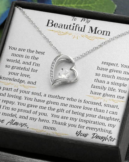 a white gold forever love necklace up close on table