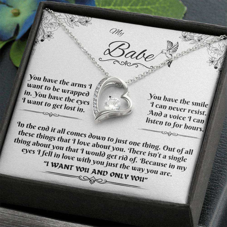 white gold forever love necklace in a soft box angled to the right