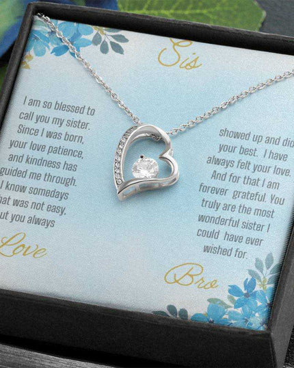 Forever Love Necklace with a white gold variant on a to sis from bro greeting card close up view in a two-tone box angled slightly to the right.