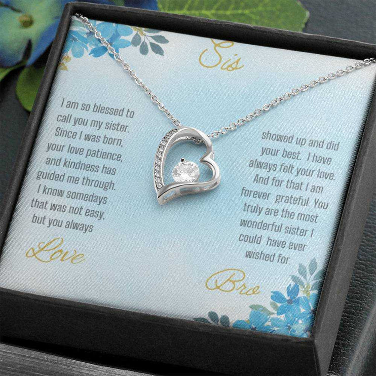Forever Love Necklace with a white gold variant on a to sis from bro greeting card close up view in a two-tone box angled slightly to the right.