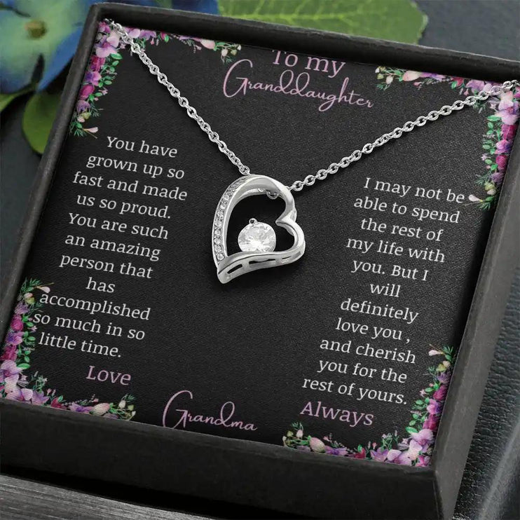 Forever Love Necklace with a white gold charm on a for granddaughter from grandpa greeting card in a two-tone box angled to the left