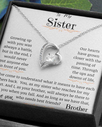 a forever love necklace up close in a models hand angled to right.